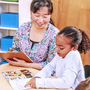 Teacher assessing a student’s reading